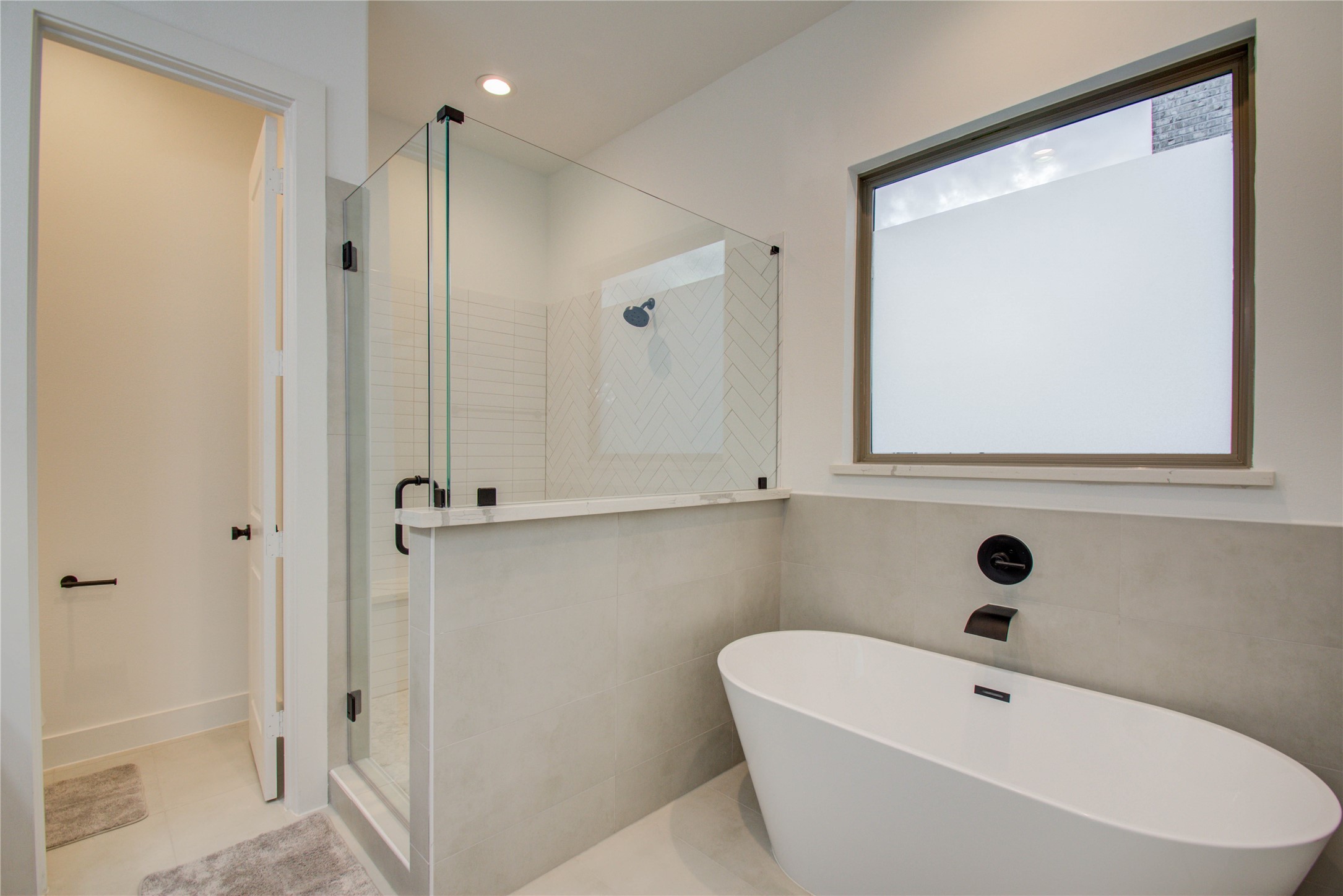 2315 Sherwin Street Houston, TX 77007 - Photo 27 of 50 a bathroom with a white tub shower vanity and a sink