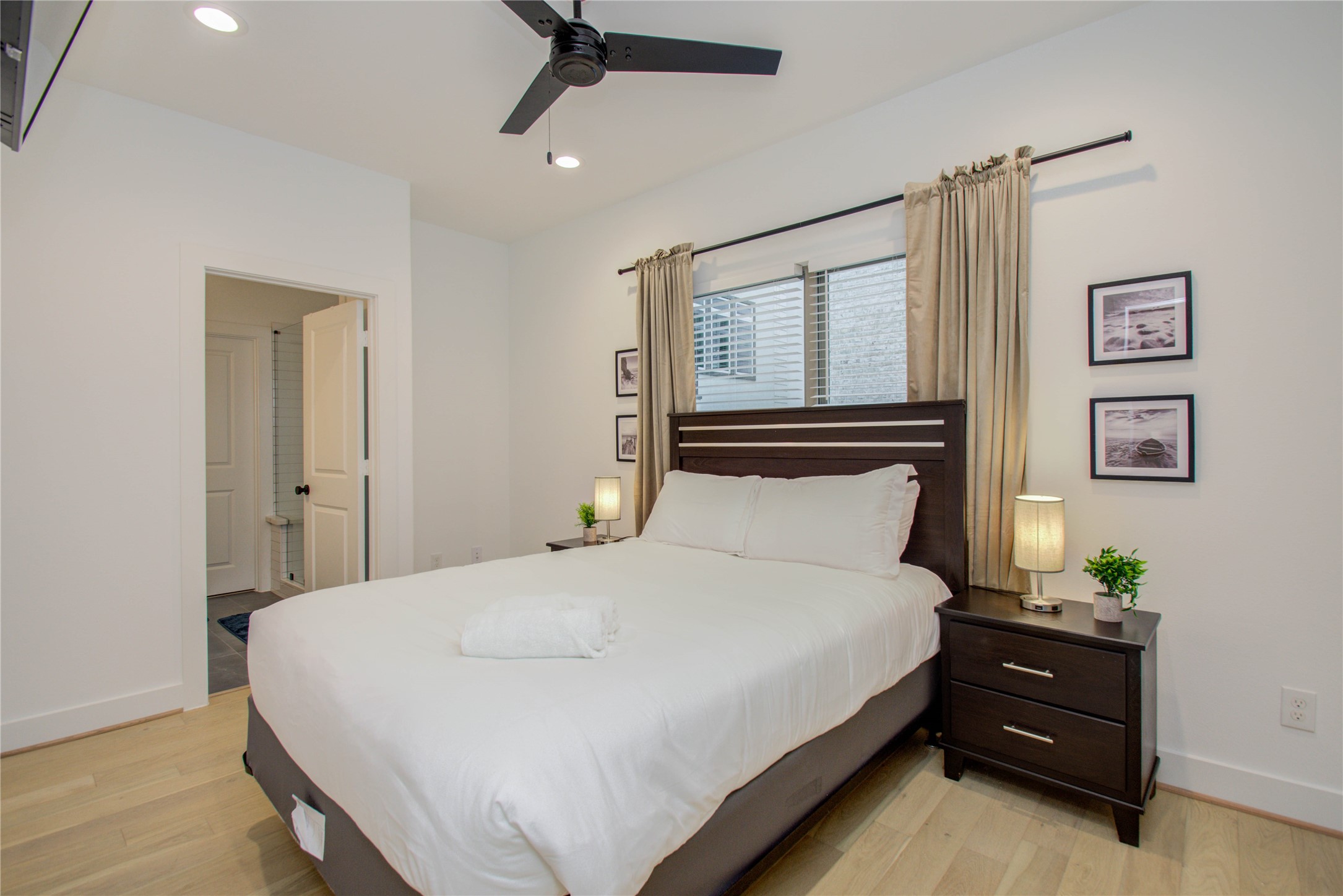 2315 Sherwin Street Houston, TX 77007 - Photo 31 of 50 a large bed sitting in a bedroom next to a window and a chandelier