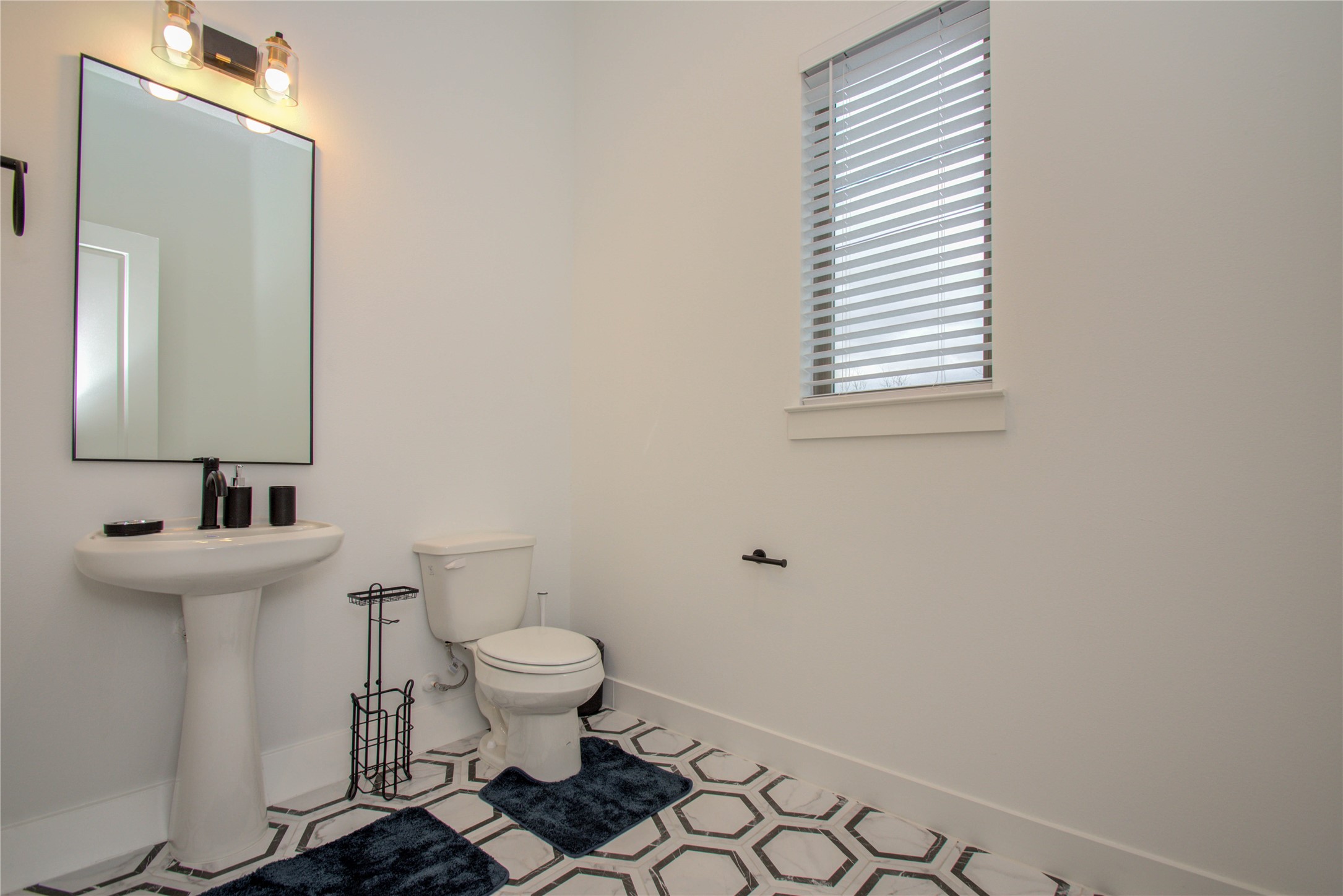 2315 Sherwin Street Houston, TX 77007 - Photo 40 of 50 a bathroom with a sink a toilet and a mirror
