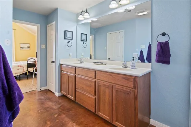 a spacious bathroom with a sink vanity and mirror