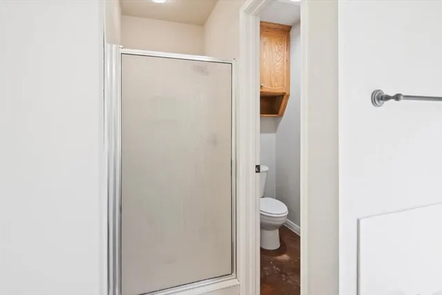 a bathroom that has a glass shower door