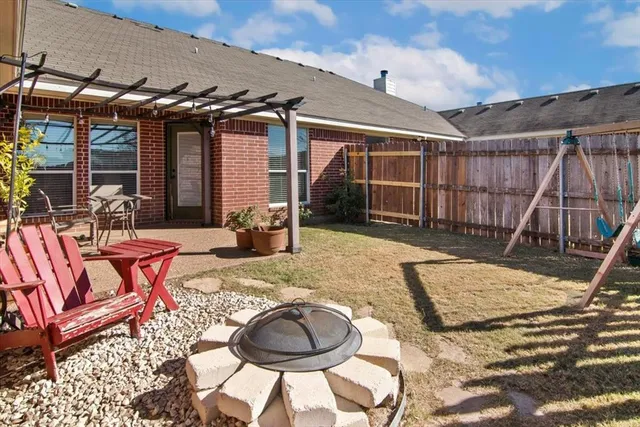 a backyard of a house with barbeque oven table and chairs