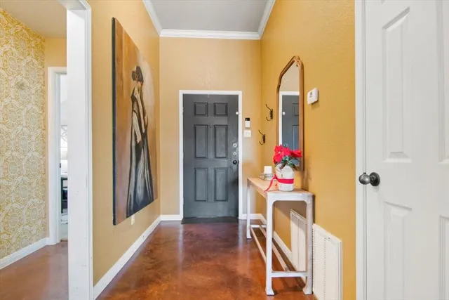 a view of a hallway with painted walls and a window