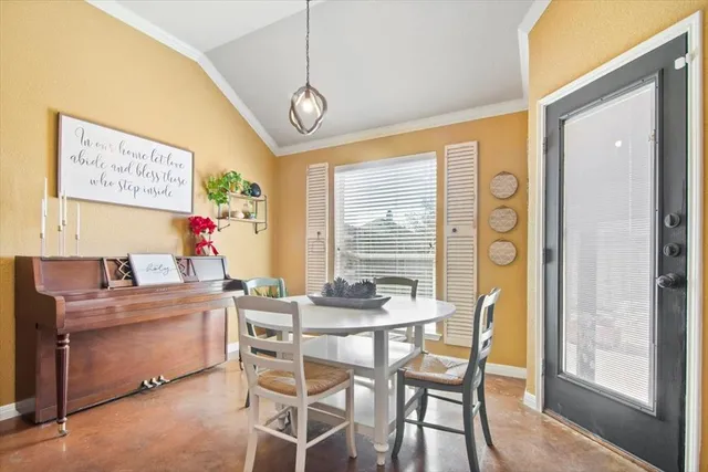 a dining room with furniture and window