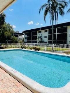 5100 Southwest 64th Avenue, Unit 101 Davie, FL 33314 - Photo 4 of 17 a view of a swimming pool with an outdoor seating