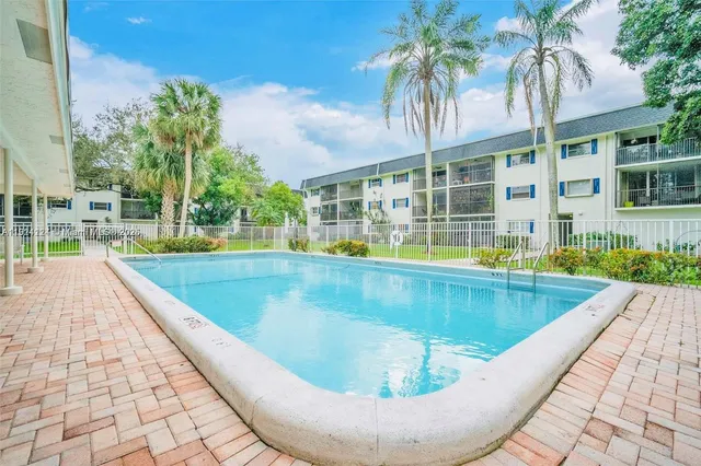 a view of a swimming pool with a lounge chair