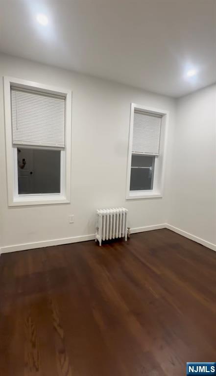 207 Valley Road, Unit 7 Clifton, NJ 07013 - Photo 5 of 8 a view of an empty room with wooden floor and a window