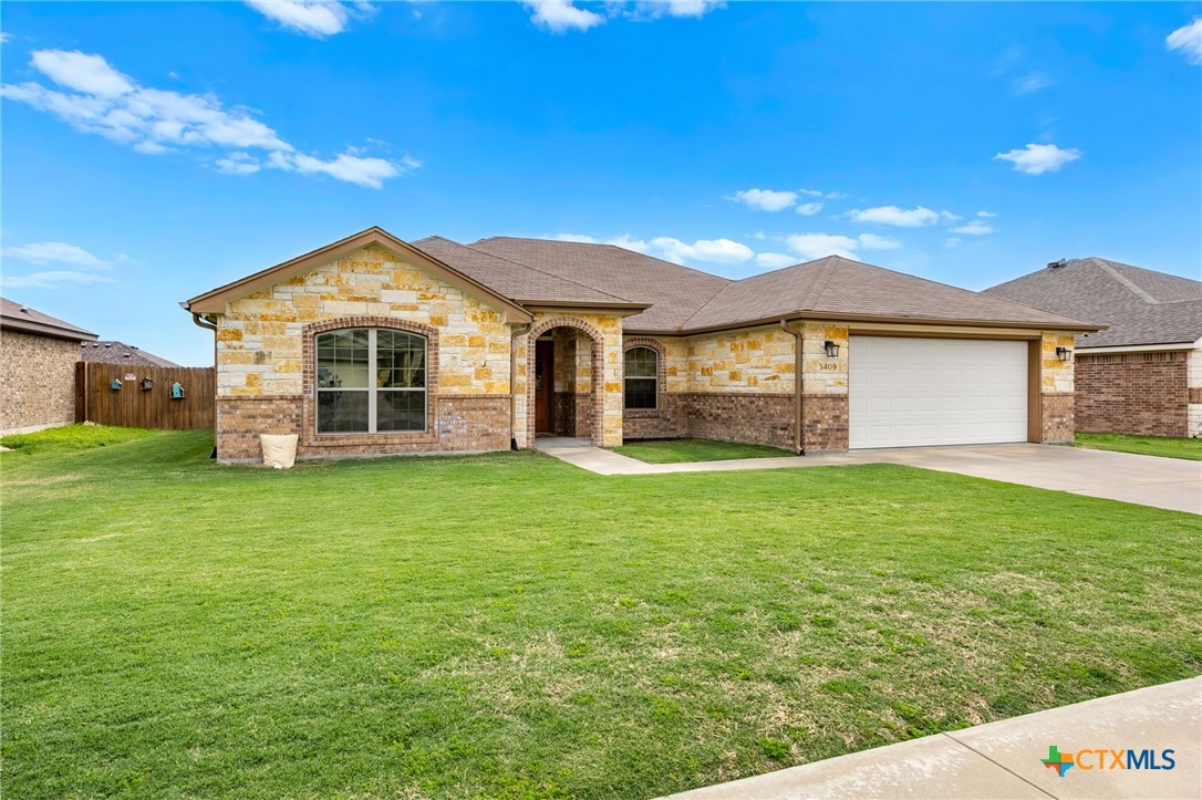 3409 Plains Street Copperas Cove, TX 76522 - Photo 1 of 33 a front view of a house with a garden