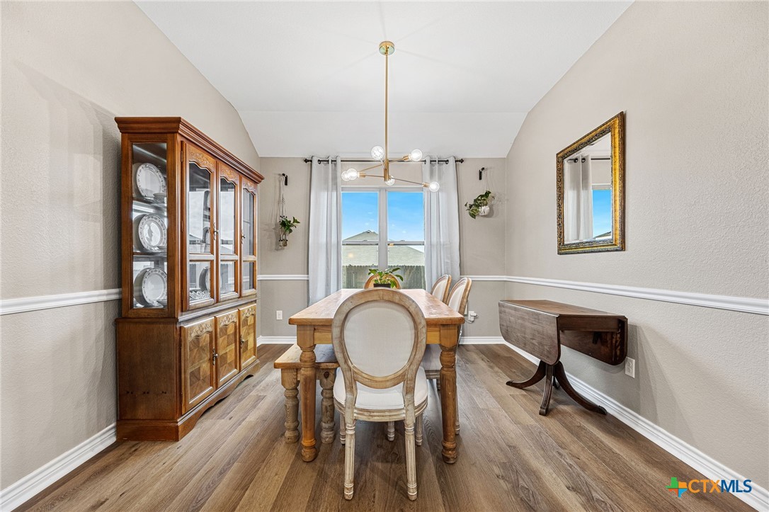 3409 Plains Street Copperas Cove, TX 76522 - Photo 11 of 33 a dining room with furniture a chandelier and wooden floor