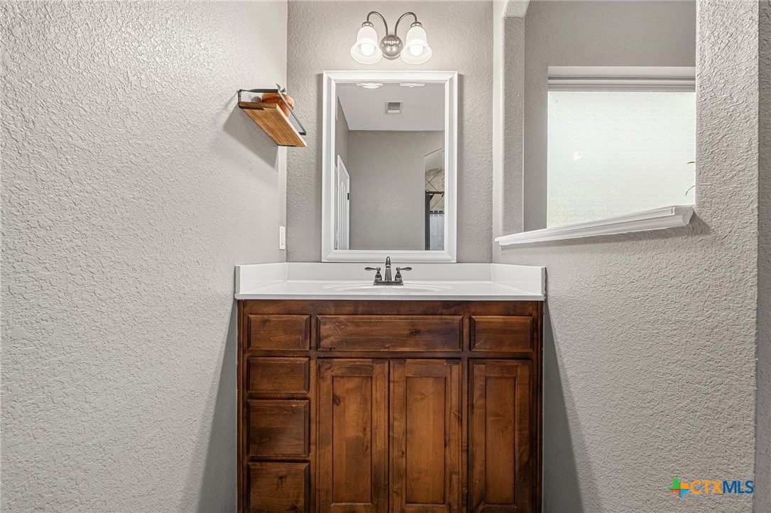 3409 Plains Street Copperas Cove, TX 76522 - Photo 13 of 33 a bathroom with a sink and a mirror