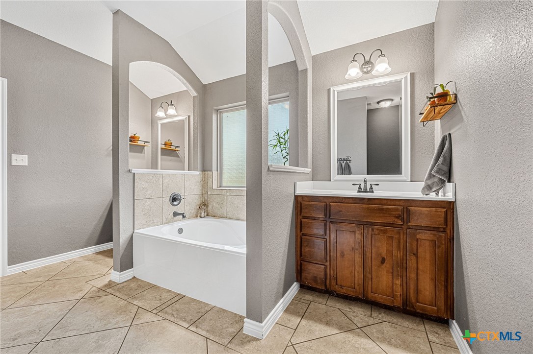3409 Plains Street Copperas Cove, TX 76522 - Photo 19 of 33 a bathroom with a tub sink and mirror