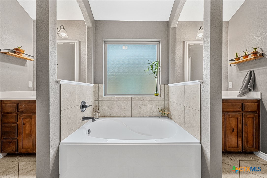 3409 Plains Street Copperas Cove, TX 76522 - Photo 20 of 33 a bathroom with a tub sink and mirror