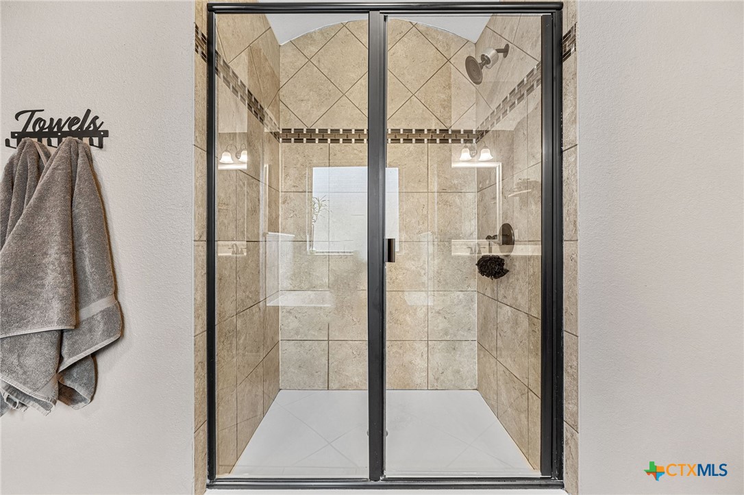 3409 Plains Street Copperas Cove, TX 76522 - Photo 21 of 33 a bathroom with a glass shower door