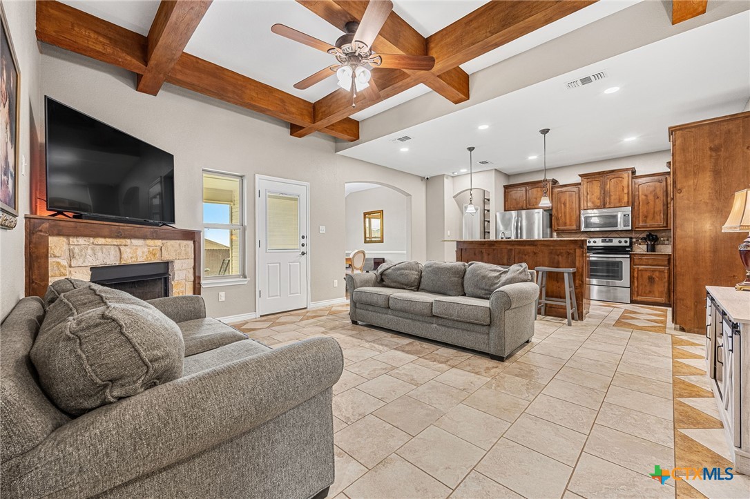 3409 Plains Street Copperas Cove, TX 76522 - Photo 5 of 33 a living room with furniture a flat screen tv and a fireplace
