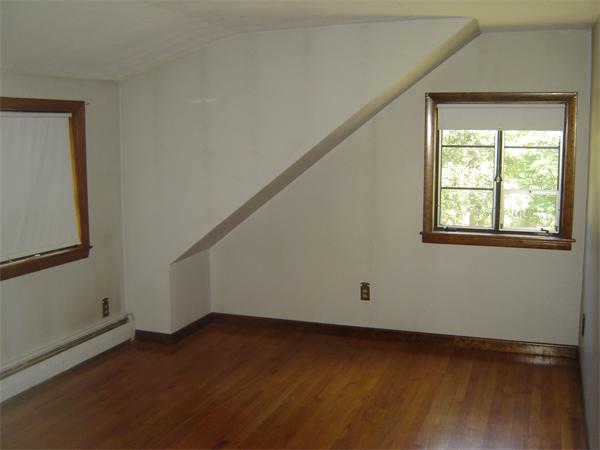 71 Southampton Road Holyoke, MA 01040 - Photo 11 of 12 a view of an empty room with wooden floor and a window