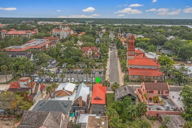 an aerial view of residential houses with outdoor space and city view