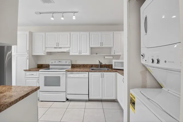 a kitchen with a stove a sink and a refrigerator