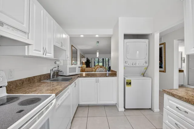 a kitchen with a sink window and cabinets
