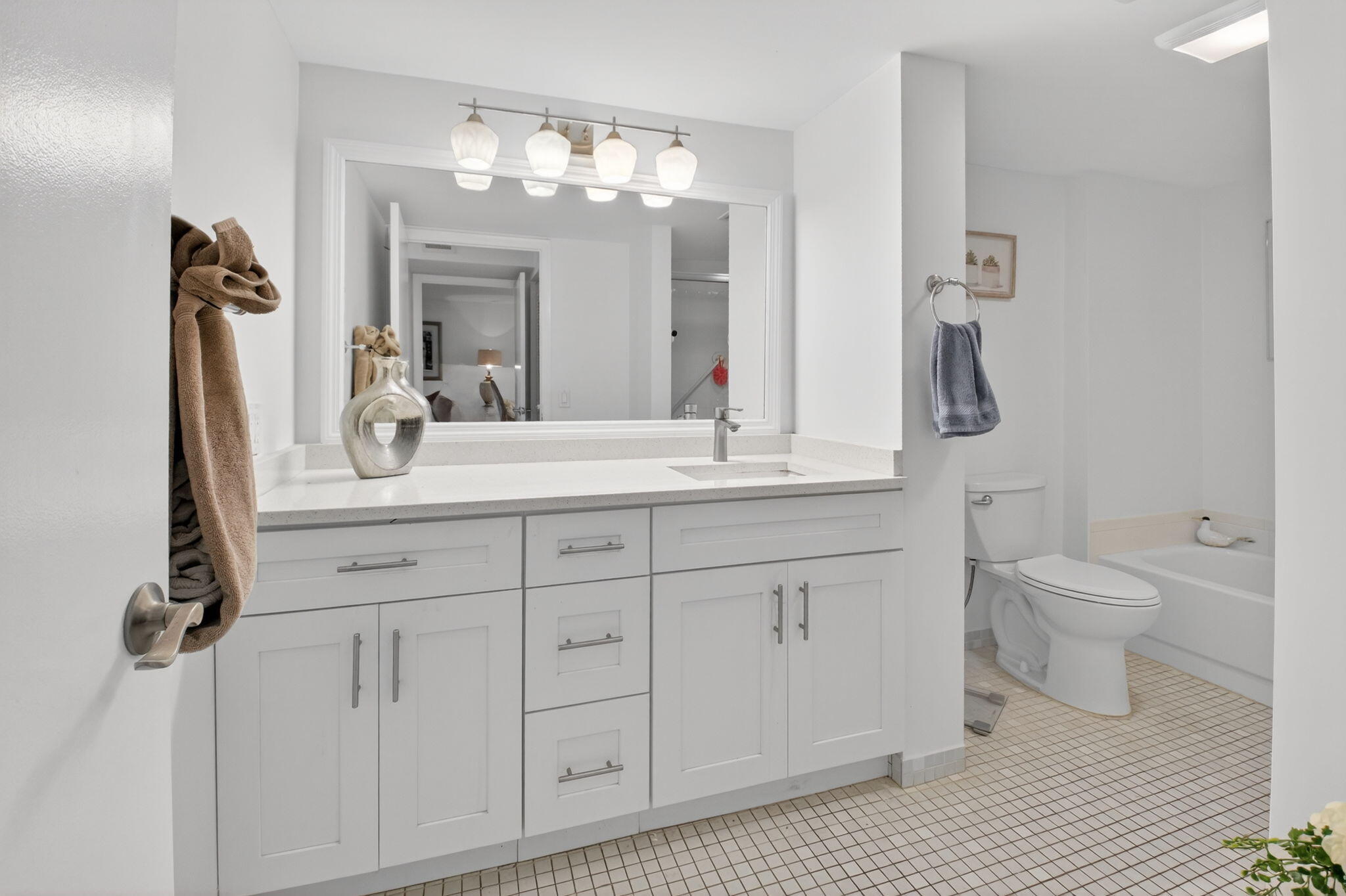 10 Southport Lane, Unit E Boynton Beach, FL 33436 - Photo 21 of 47 a bathroom with a sink a toilet and a mirror
