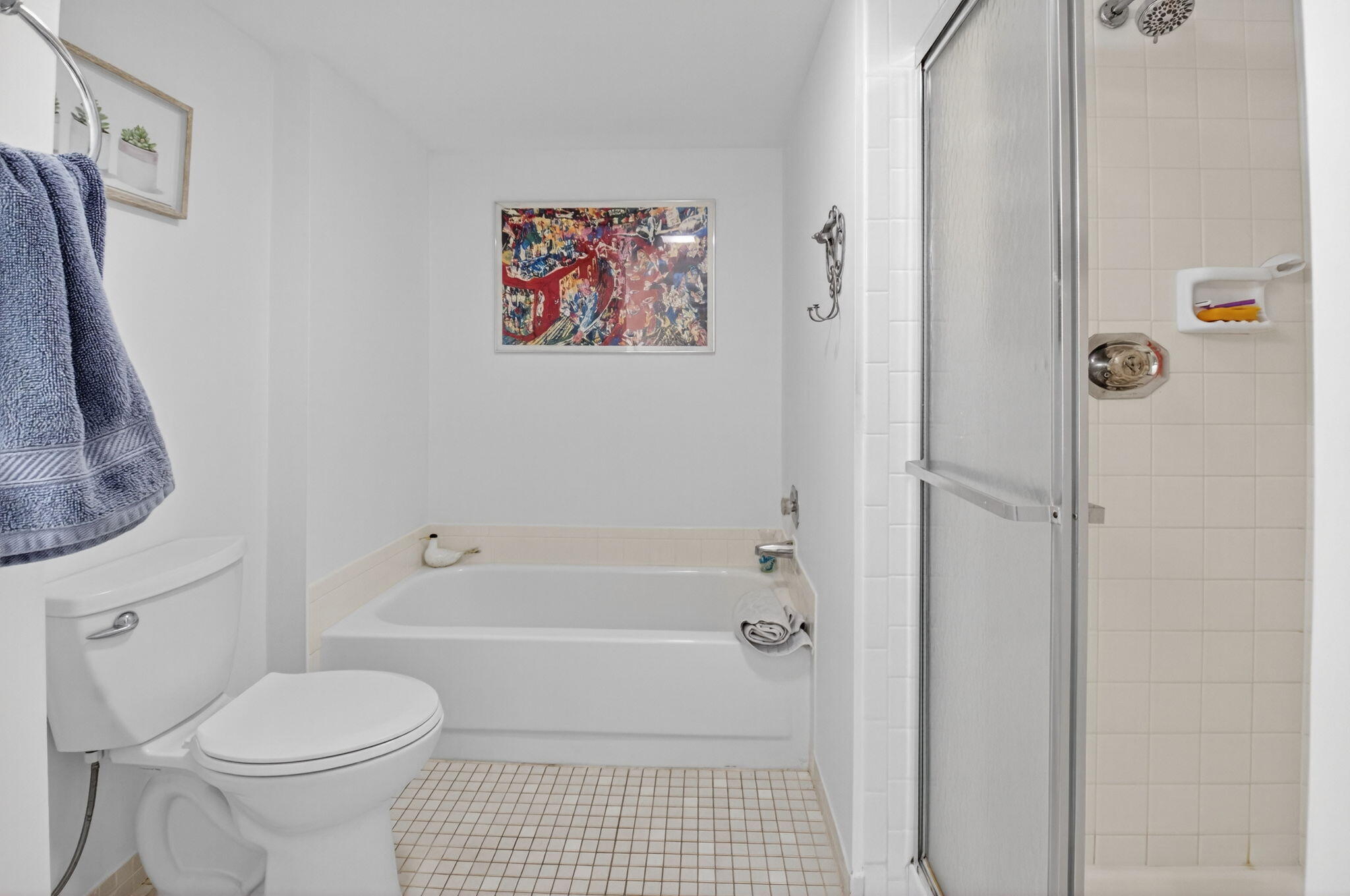10 Southport Lane, Unit E Boynton Beach, FL 33436 - Photo 22 of 47 a bathroom with a toilet and a shower