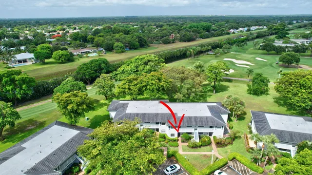 an aerial view of a house with yard and outdoor seating