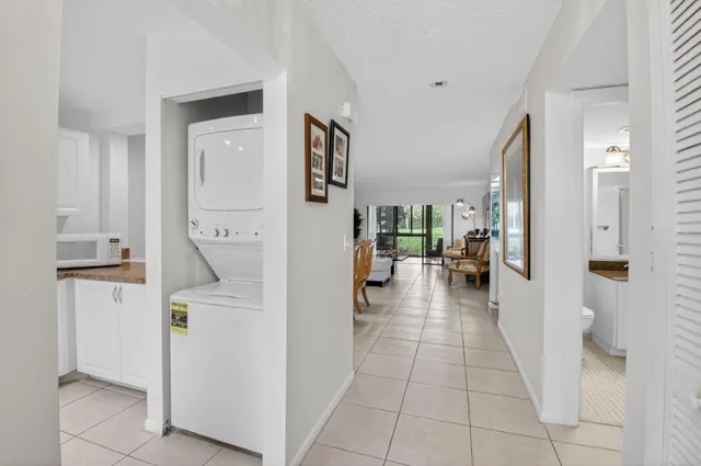 a view of a kitchen with refrigerator and furniture