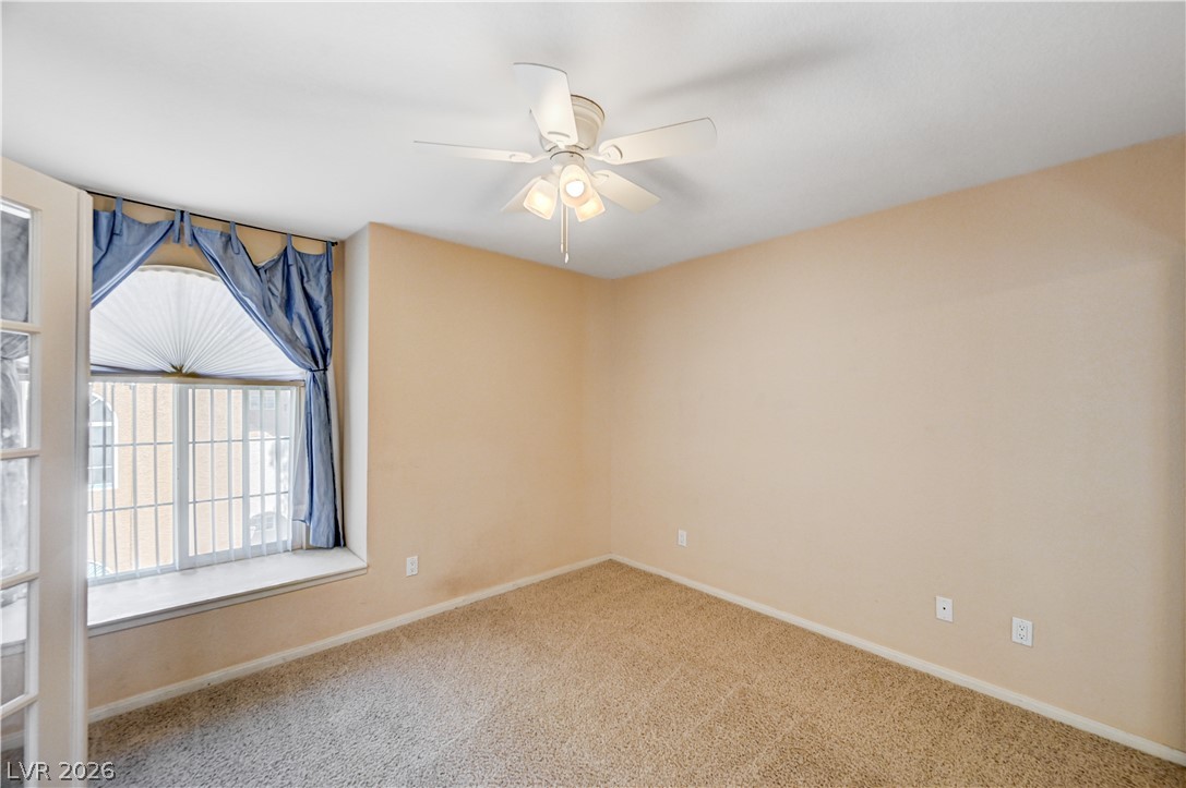 9325 West Desert Inn Road, Unit 226 Las Vegas, NV 89117 - Photo 26 of 29 An airy bedroom with a ceiling fan offers comfortable living.