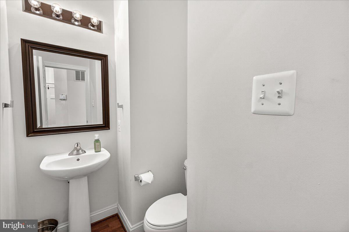 411 William Plummer Street New Market, MD 21774 - Photo 12 of 89 a bathroom with a toilet sink and mirror