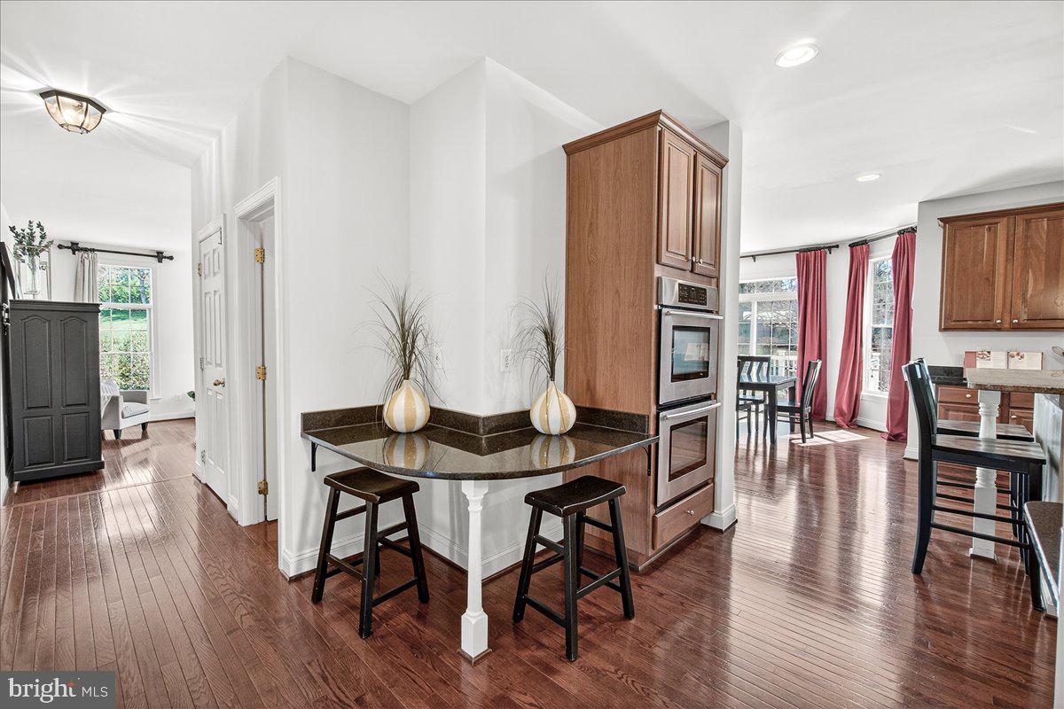 411 William Plummer Street New Market, MD 21774 - Photo 19 of 89 a view of a dining room with furniture and wooden floor