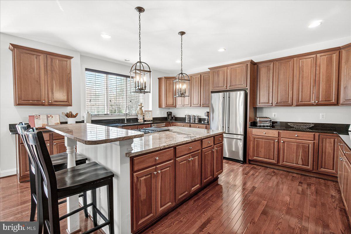 411 William Plummer Street New Market, MD 21774 - Photo 20 of 89 a kitchen with stainless steel appliances granite countertop a sink stove and refrigerator