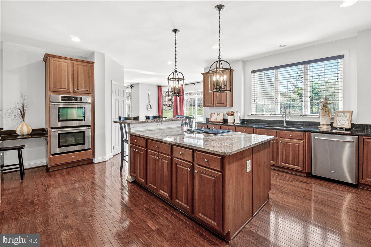 411 William Plummer Street New Market, MD 21774 - Photo 23 of 89 a kitchen with a sink stove and wooden cabinets