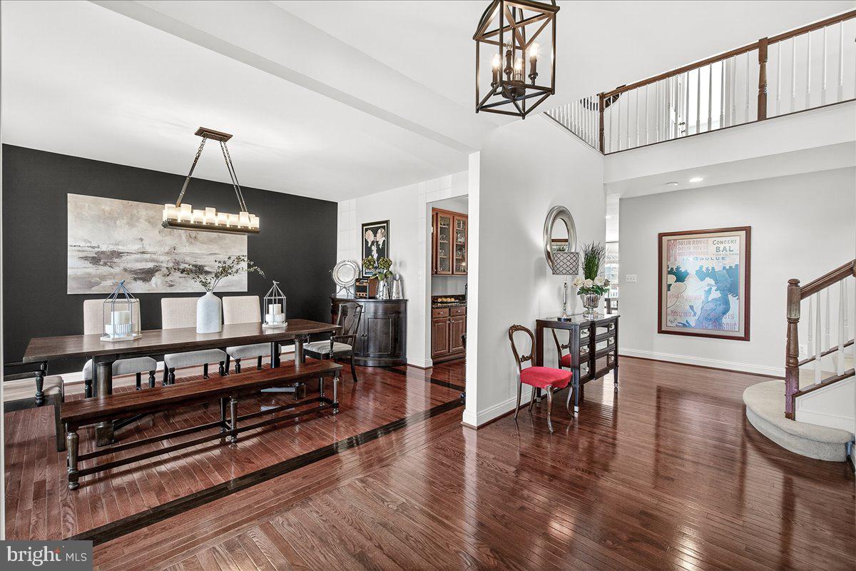 411 William Plummer Street New Market, MD 21774 - Photo 5 of 89 a dining room with wooden floor a chandelier a wooden table and chairs