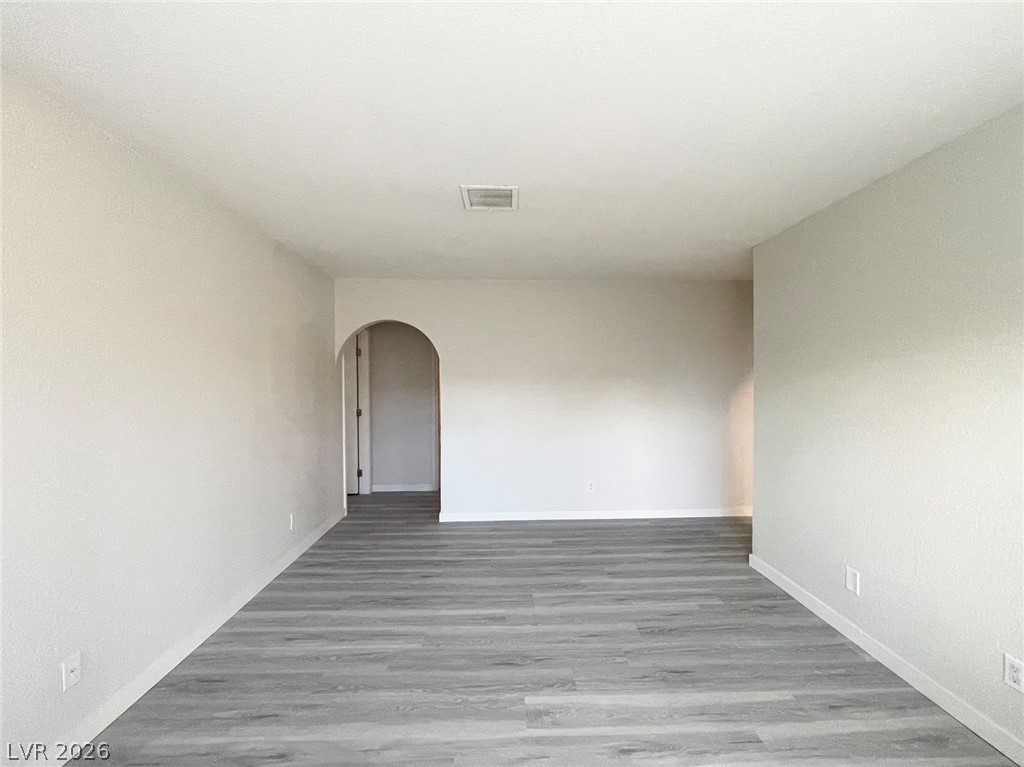 1834 North Decatur Boulevard, Unit 204 Las Vegas, NV 89108 - Photo 10 of 17 A spacious, naturally illuminated room features light wood flooring and an arched doorway.