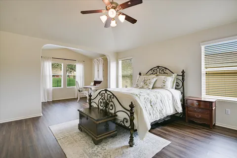 a bedroom with a bed and wooden floor