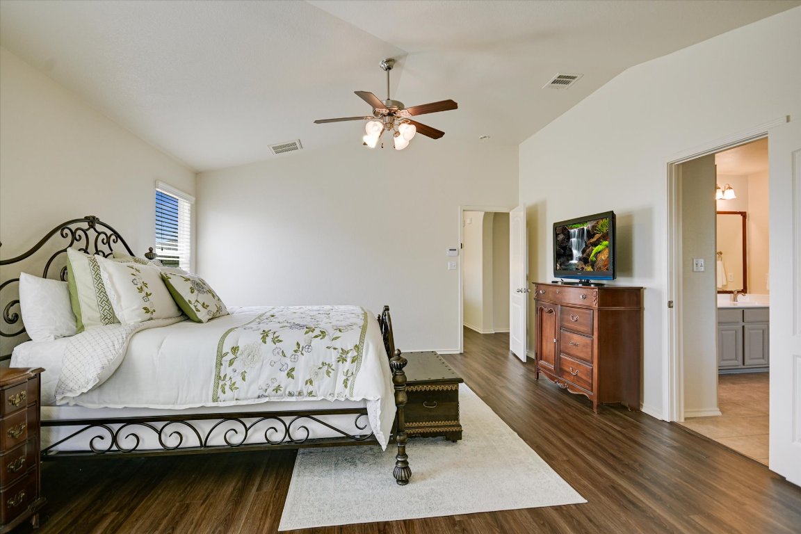 7212 Lookout Bluff Terrace, Unit D18 Austin, TX 78735 - Photo 15 of 22 a bedroom with a bed and a chandelier