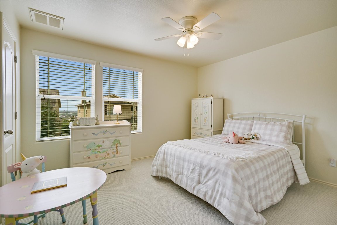 7212 Lookout Bluff Terrace, Unit D18 Austin, TX 78735 - Photo 18 of 22 a bedroom with a bed and a table