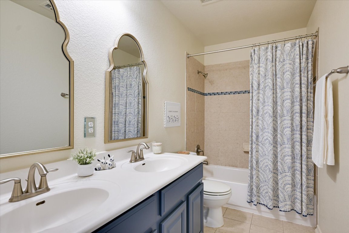 7212 Lookout Bluff Terrace, Unit D18 Austin, TX 78735 - Photo 20 of 22 a bathroom with a double vanity sink toilet and shower