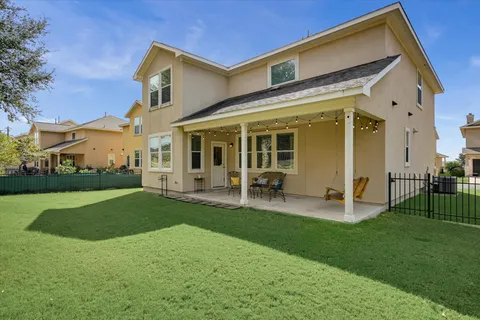 a view of a house with a yard and sitting area