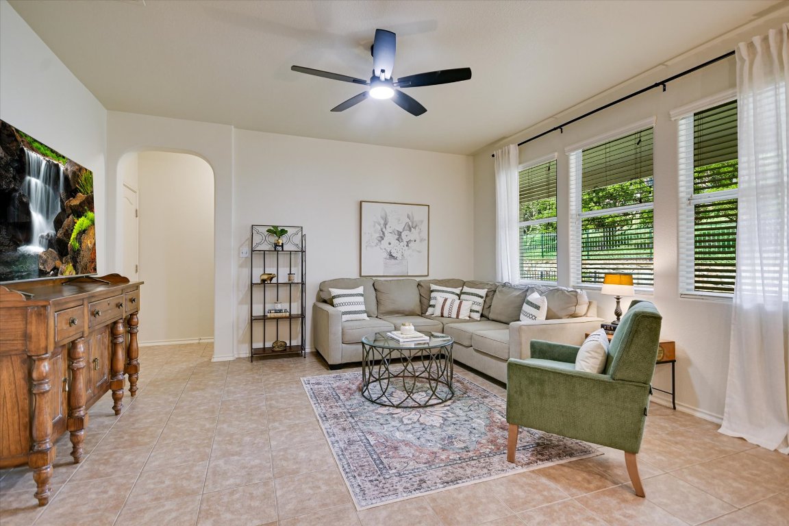 7212 Lookout Bluff Terrace, Unit D18 Austin, TX 78735 - Photo 4 of 22 a living room with furniture a flat screen tv and a large window