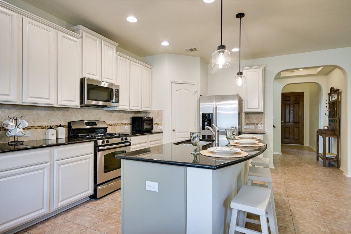 7212 Lookout Bluff Terrace, Unit D18 Austin, TX 78735 - Photo 8 of 22 a kitchen with sink a stove and cabinets