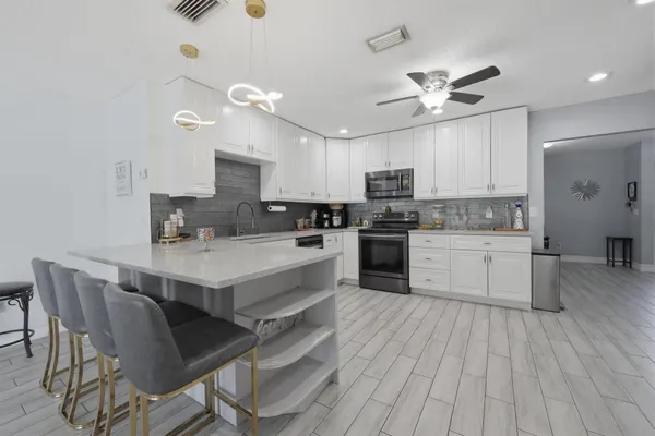 a kitchen with a stove a sink and a refrigerator
