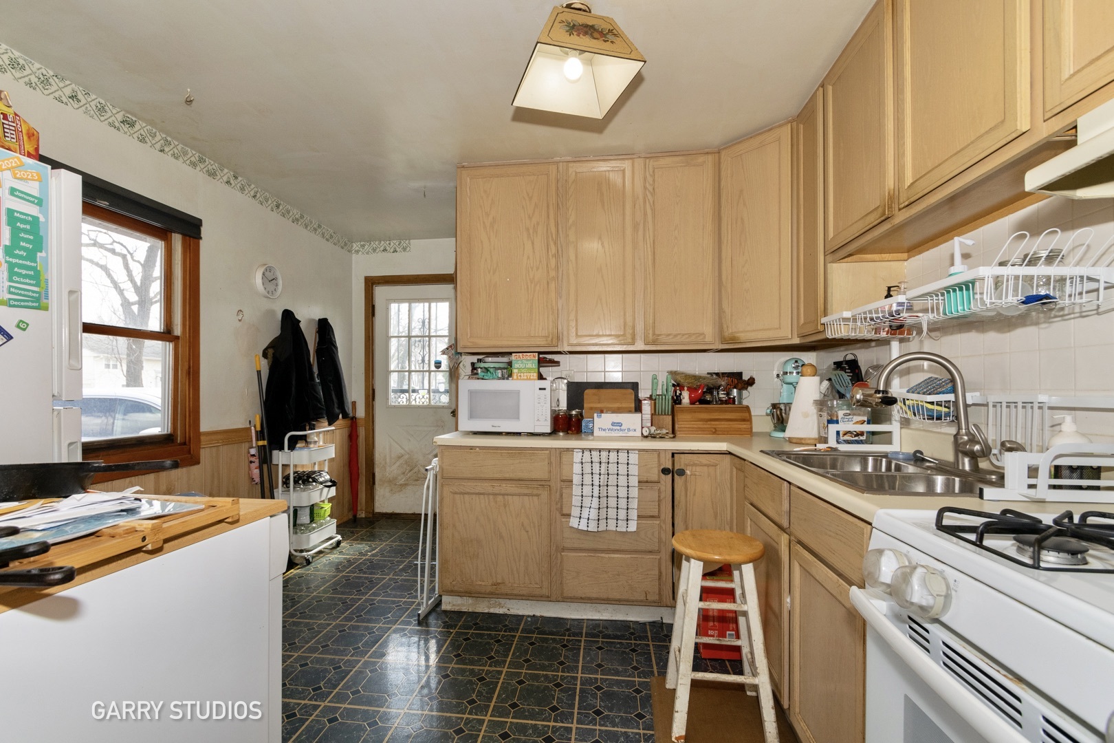 306 South Oltendorf Road Streamwood, IL 60107 - Photo 5 of 15 a kitchen with a sink and cabinets