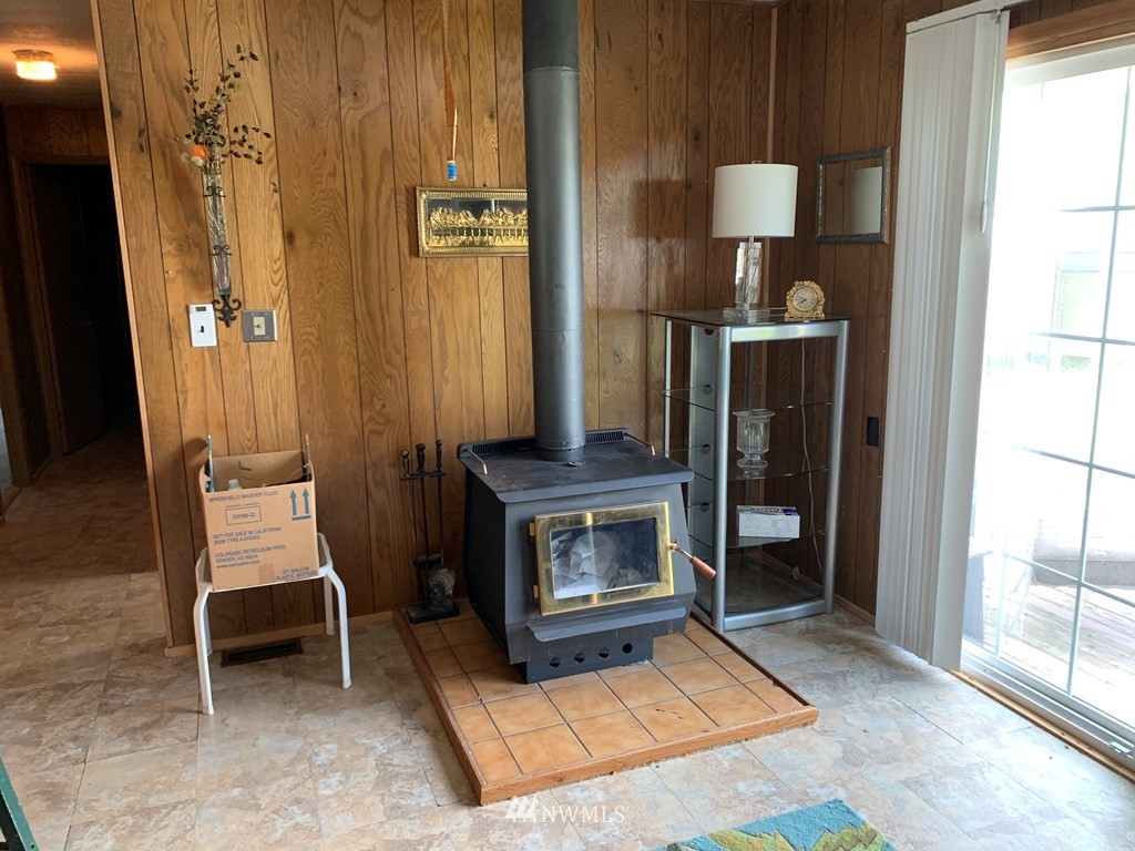 612 Harlem Road Dayton, WA 99328 - Photo 22 of 32 a living room with furniture a window and a fireplace