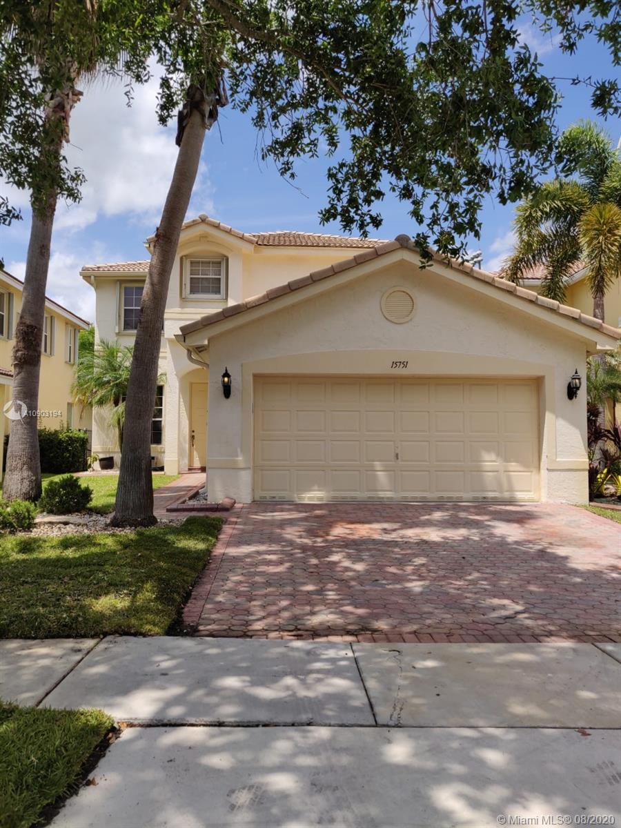 15751 Southwest 20th Street Miramar, FL 33027 - Photo 1 of 34 a front view of a house with a garden and yard
