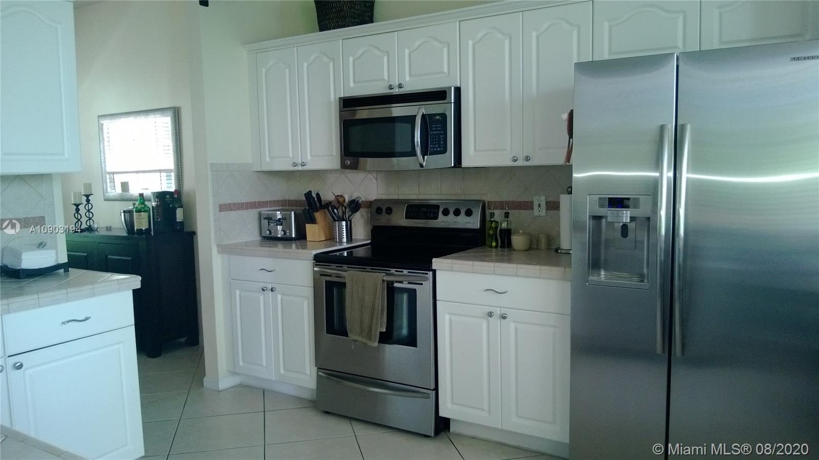 15751 Southwest 20th Street Miramar, FL 33027 - Photo 12 of 34 a kitchen with cabinets stainless steel appliances and a counter space