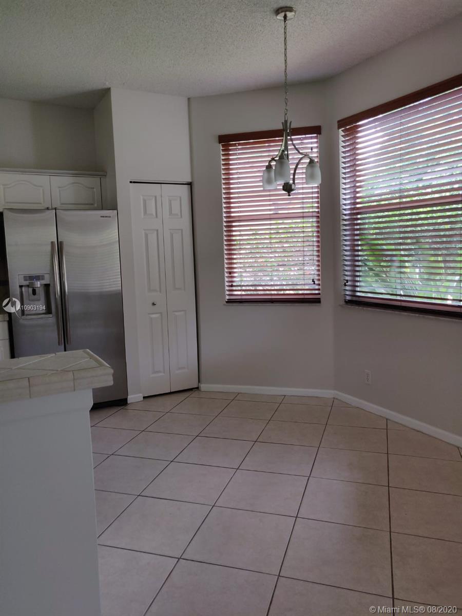 15751 Southwest 20th Street Miramar, FL 33027 - Photo 14 of 34 a dining table chair and window in a room