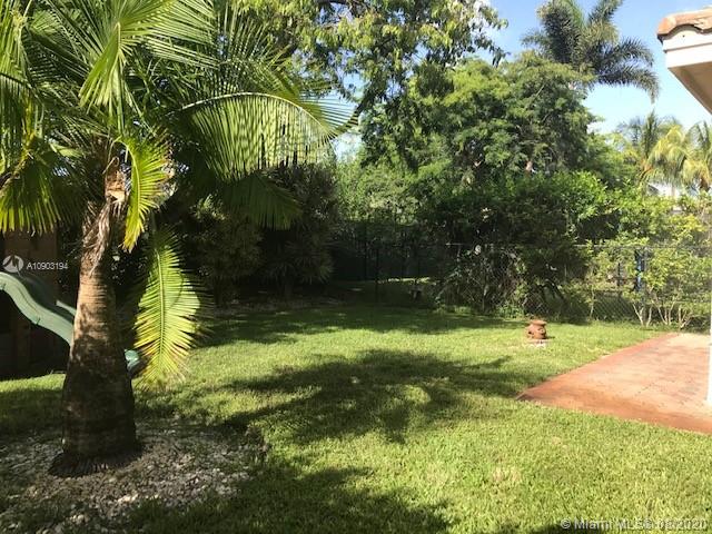 15751 Southwest 20th Street Miramar, FL 33027 - Photo 30 of 34 a view of a yard with plants and large trees