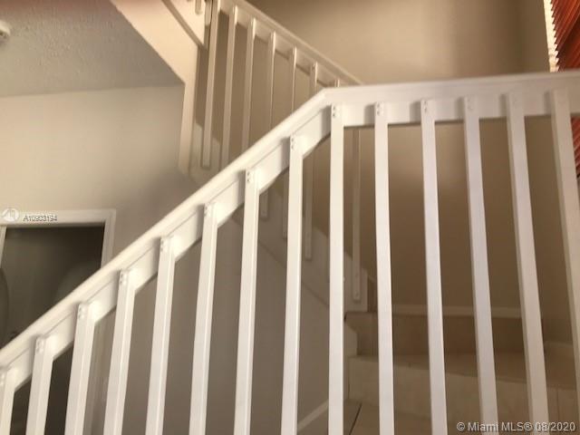 15751 Southwest 20th Street Miramar, FL 33027 - Photo 6 of 34 a view of wooden staircase with railing and white walls