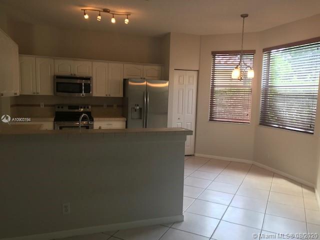 15751 Southwest 20th Street Miramar, FL 33027 - Photo 10 of 34 a kitchen with stainless steel appliances a refrigerator and a stove