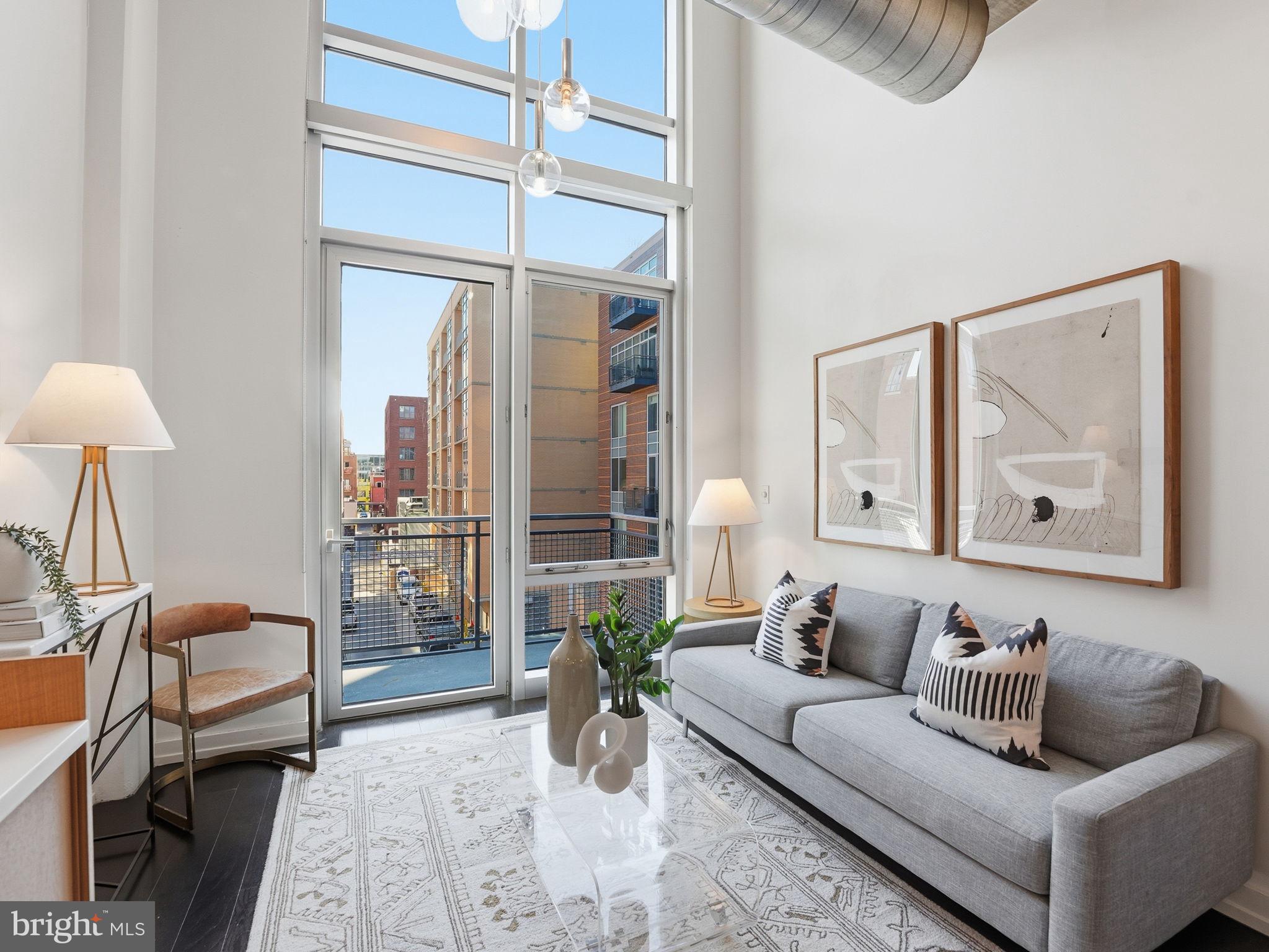 1515 15th Street Northwest, Unit 403 Washington, DC 20005 - Photo 4 of 26 Dramatic two-story floor-to-ceiling windows.